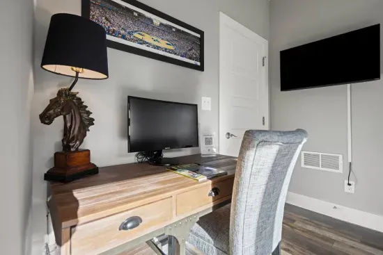 First floor entryway offers a pull-out queen sofa bed, smart tv, and dedicated workspace including an external computer monitor for your convenience, including a half bath.