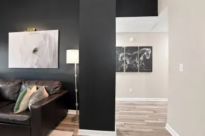 Stylish lounge with leather seating, bold art, and modern flair