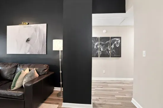Stylish lounge with leather seating, bold art, and modern flair