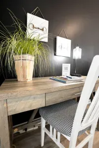 Chic workspace with rustic desk, accent wall, and cozy designer touches