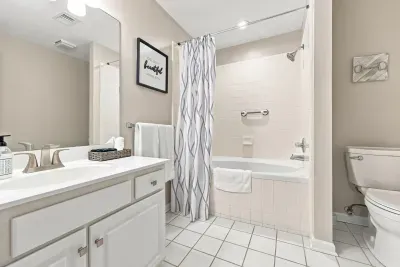 Bright, clean full bathroom with tub-shower combo and spacious vanity