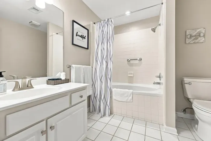 Bright, clean full bathroom with tub-shower combo and spacious vanity