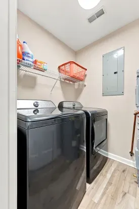 Convenient in-home laundry room with full-size washer, dryer, and storage