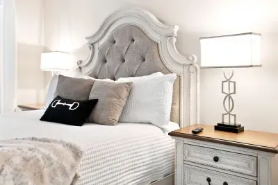 Elegant bedroom with a statement headboard and soft, layered bedding