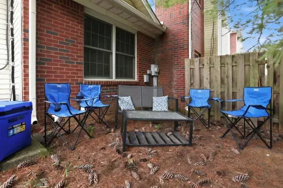 Private fenced patio with outdoor seating for a relaxed group hangout