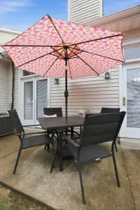Private patio dining with shaded seating and a cheerful oversized umbrella
