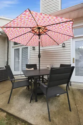 Private patio dining with shaded seating and a cheerful oversized umbrella