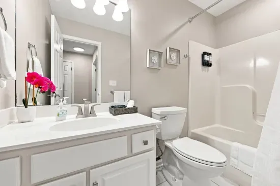 Bright, spotless bathroom with full tub-shower and spacious vanity