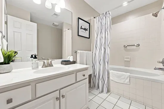 Bright full bathroom with spacious vanity and tub/shower combo