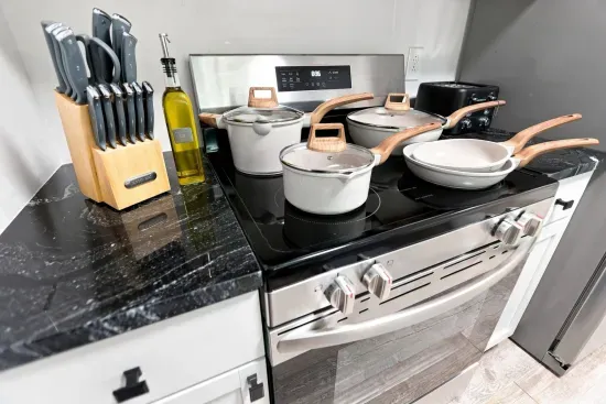 Fully stocked modern kitchen with sleek cookware and stainless range