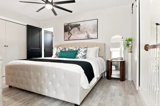 Bright modern bedroom with plush tufted bed and stylish designer touches
