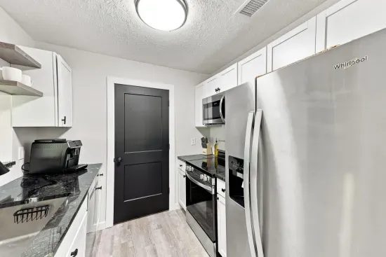 Modern galley kitchen with stainless appliances and stylish finishes