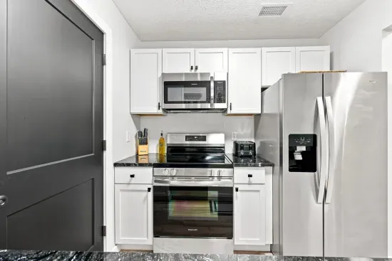 Modern kitchen with stainless appliances and crisp white cabinetry