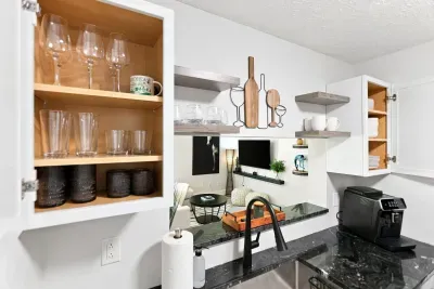 Stylish stocked kitchen with coffee station and open living-room view