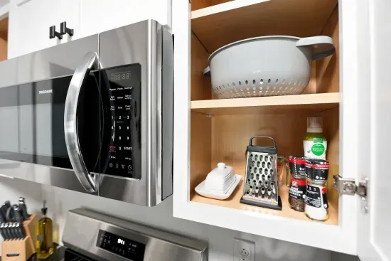 Modern kitchen with stainless appliances and well-stocked cooking essentials