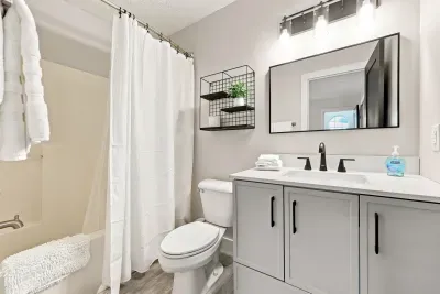 Bright modern bathroom with sleek vanity and tub-shower combo
