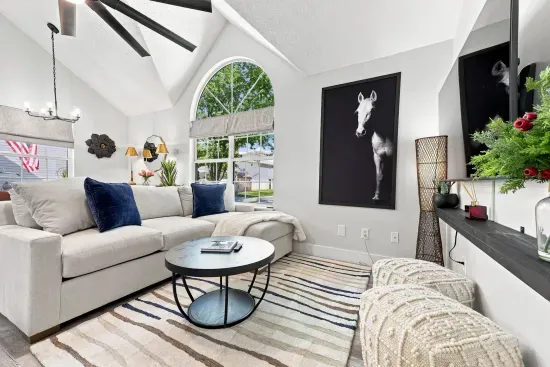 Bright vaulted living room with arched window and stylish modern decor