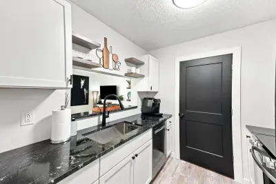 Modern kitchen with sleek black accents and stylish open shelving