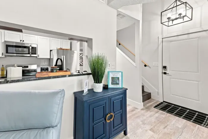 Bright modern entry with vaulted ceilings and sleek open kitchen