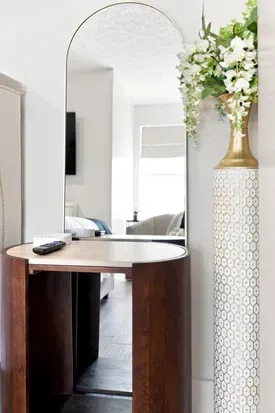 Elegant vanity nook with arched mirror and bright, airy style