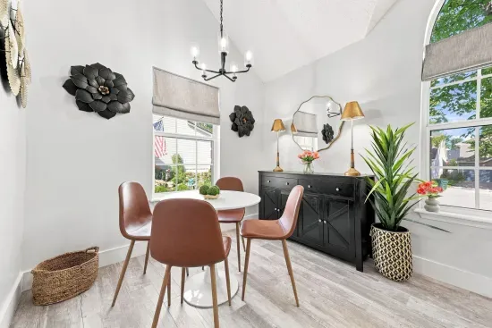 Bright, stylish dining nook with vaulted ceilings and abundant natural light