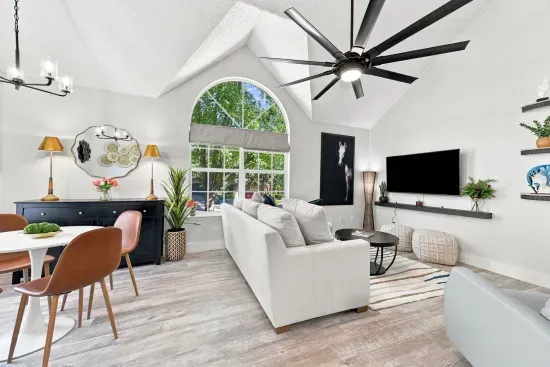 Bright vaulted living space with arched window and stylish modern decor
