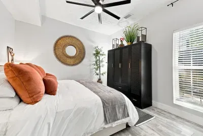 Bright modern bedroom with cozy accents, natural light, and stylish decor