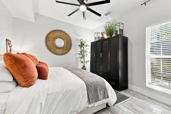 Bright modern bedroom with cozy accents, natural light, and stylish decor