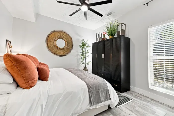 Bright modern bedroom with cozy accents, natural light, and stylish decor