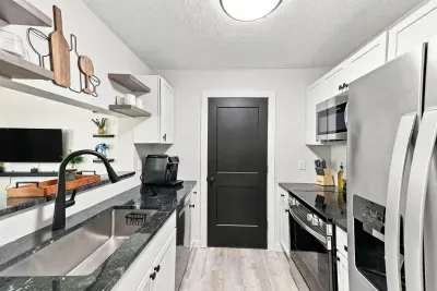 Modern galley kitchen with stainless appliances and stylish finishes