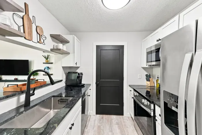 Modern galley kitchen with stainless appliances and stylish finishes