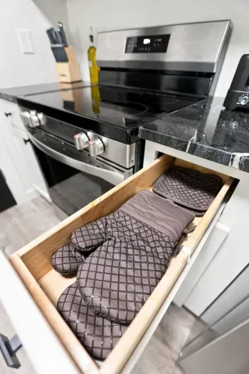 Modern kitchen with stocked oven essentials and sleek stainless range