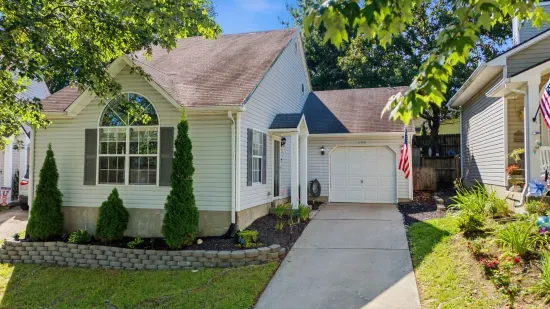 Charming home with private driveway, garage, and lovely curb appeal