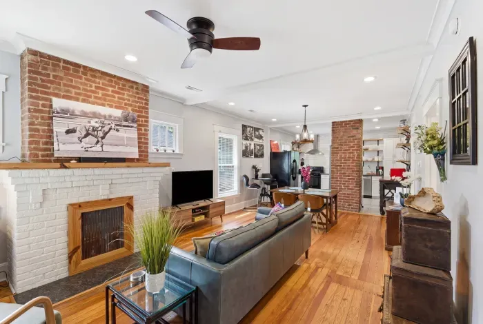 Bright open living space with exposed brick and warm hardwood floors