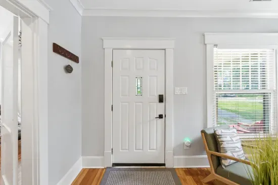 Bright, welcoming entryway with hardwood floors and natural light