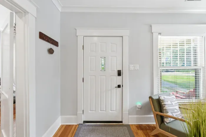 Bright, welcoming entryway with hardwood floors and natural light