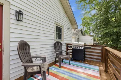 Private deck with grill, seating, and a colorful outdoor lounge area