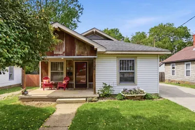 Charming home with cozy front porch, shaded yard, and private driveway