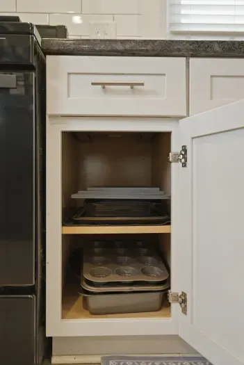 Well-stocked kitchen storage with baking essentials close at hand