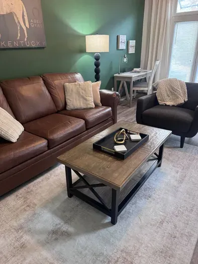 Open concept living area including a queen sleeper sofa, smart tv, dedicated office space