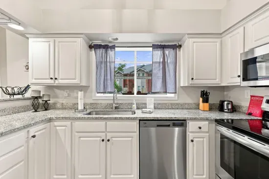 Bright modern kitchen with granite counters and stainless appliances
