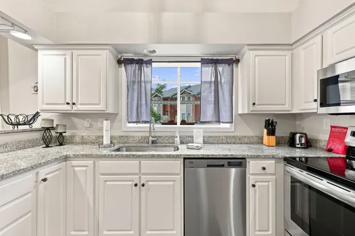 Bright modern kitchen with granite counters and stainless appliances