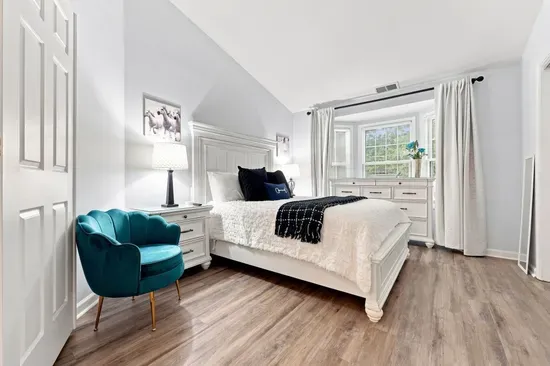 Bright, elegant bedroom with vaulted ceilings and cozy designer touches