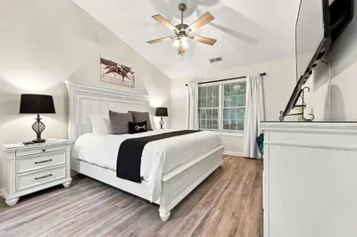 Bright, spacious king bedroom with vaulted ceilings and stylish finishes