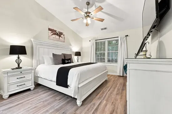 Bright, spacious king bedroom with vaulted ceilings and stylish finishes