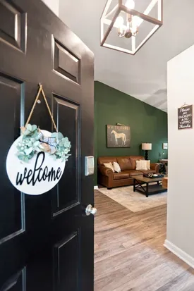 Warm welcome entry with stylish living room and cozy leather seating