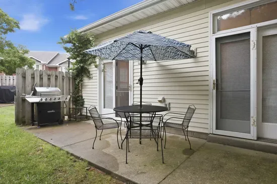 Private patio with shaded dining and grill for easy outdoor meals