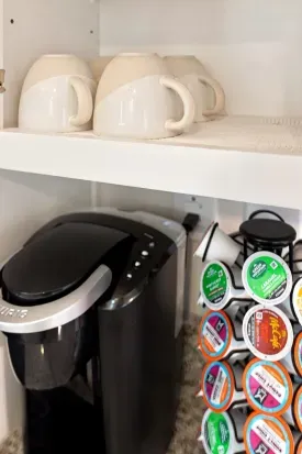 Convenient coffee station with Keurig, mugs, and assorted pod selection