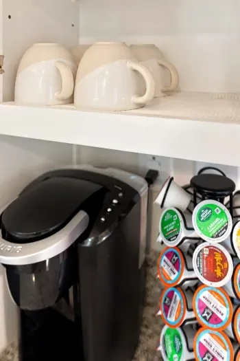 Convenient coffee station with Keurig, mugs, and assorted pod selection