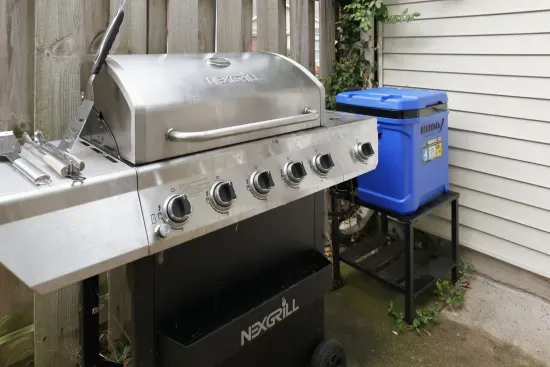 Private outdoor grill setup with cooler for easy backyard BBQs